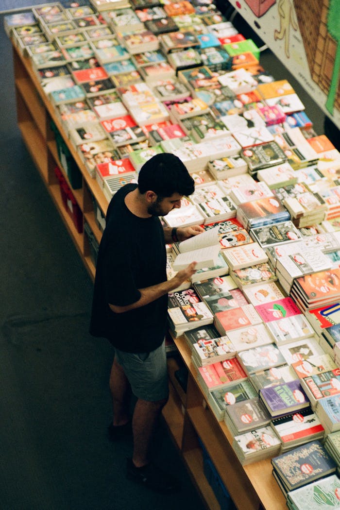 services-02 A man browses books at a bookstore in Toronto, capturing a quiet moment of casual reading.